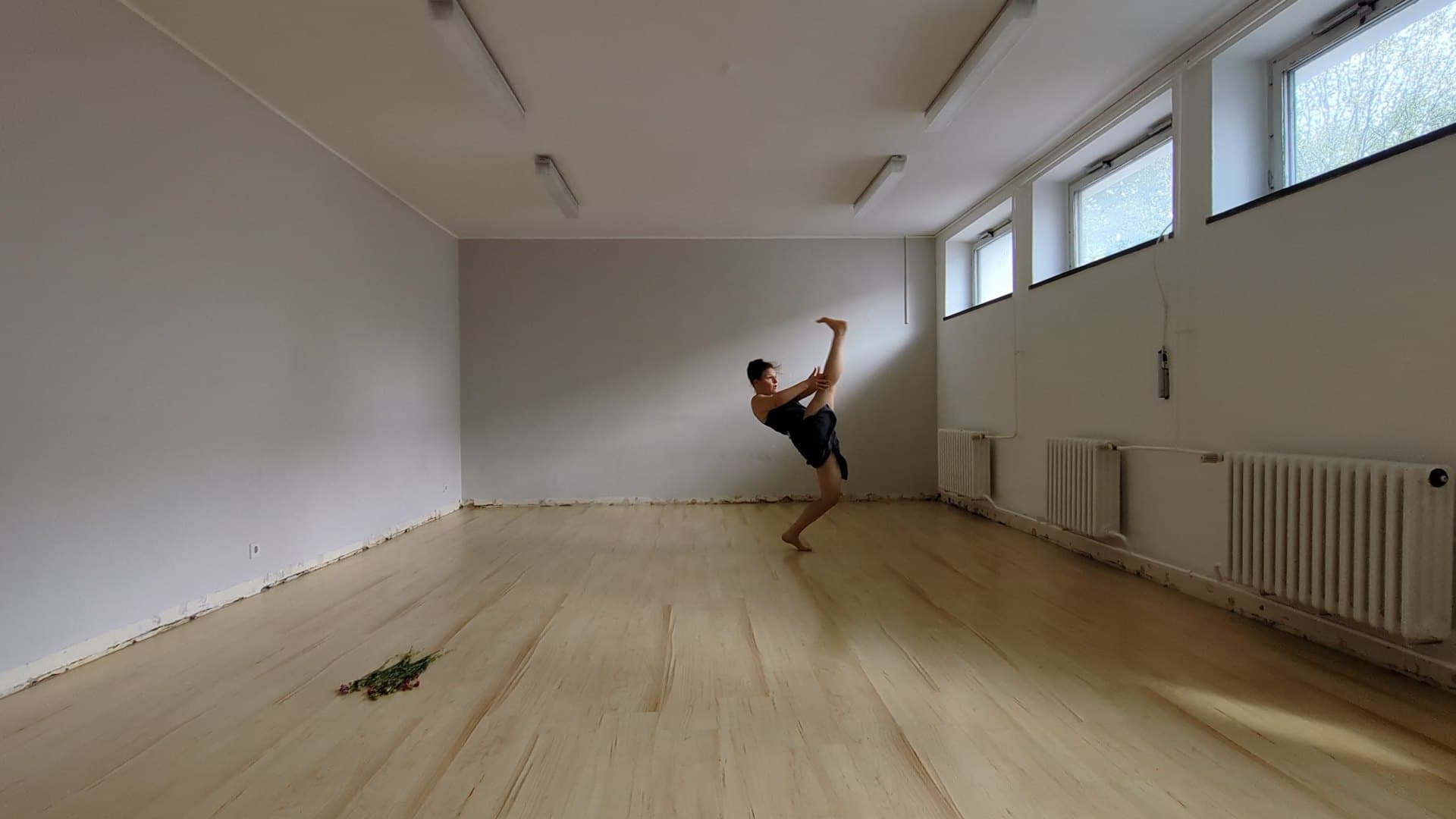 Laura mid-movement in a bright white studio