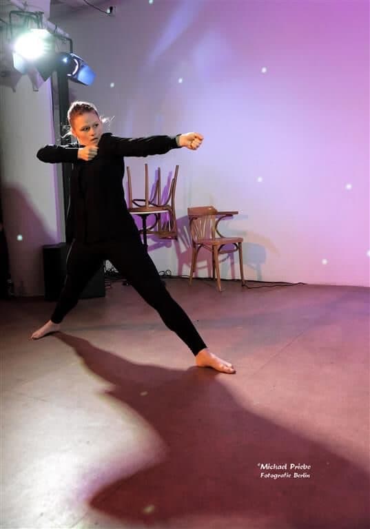 Laura pointing forward, arm outstretched