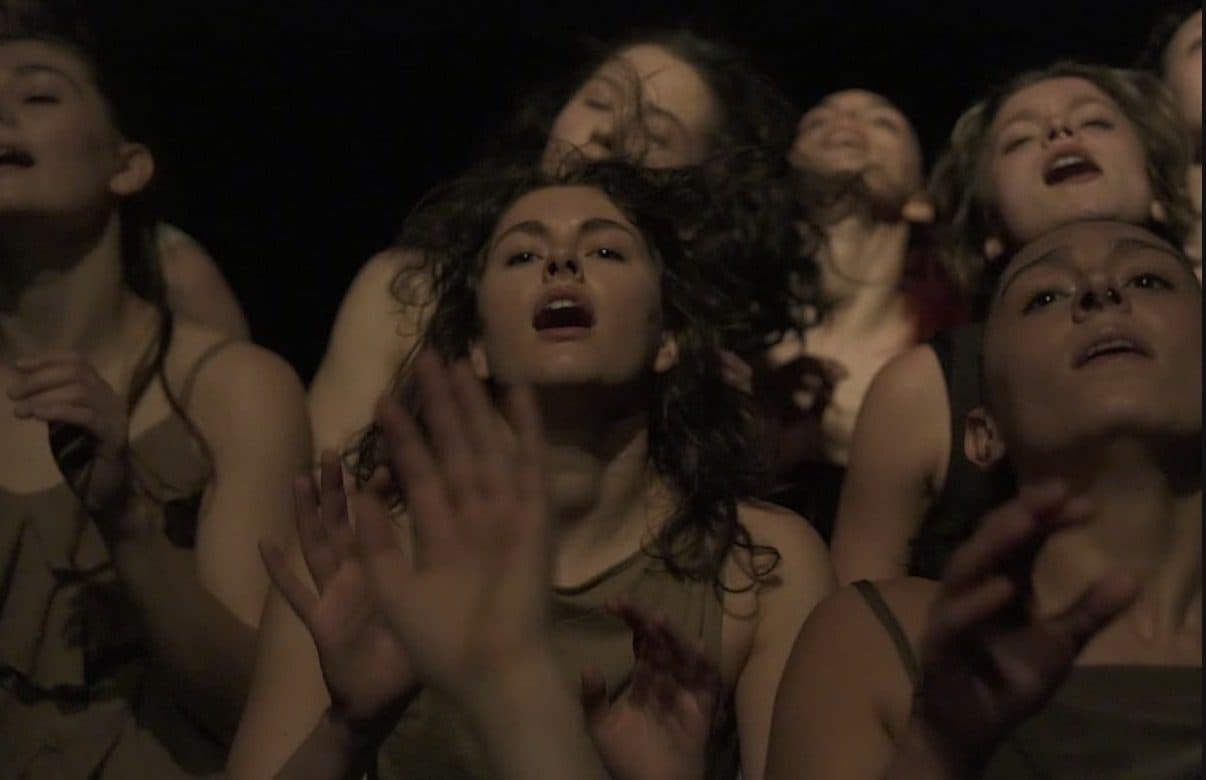 Dancers reaching upward together